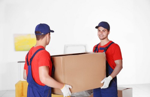 Removal team planning a move in Dollishill with packing boxes and furniture