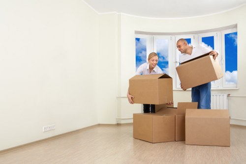 Removal crew carrying furniture through a residential property in Dollishill