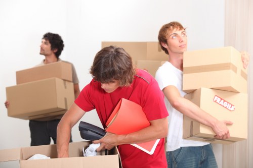 Office removal team preparing desks and equipment for a move in Dollishill